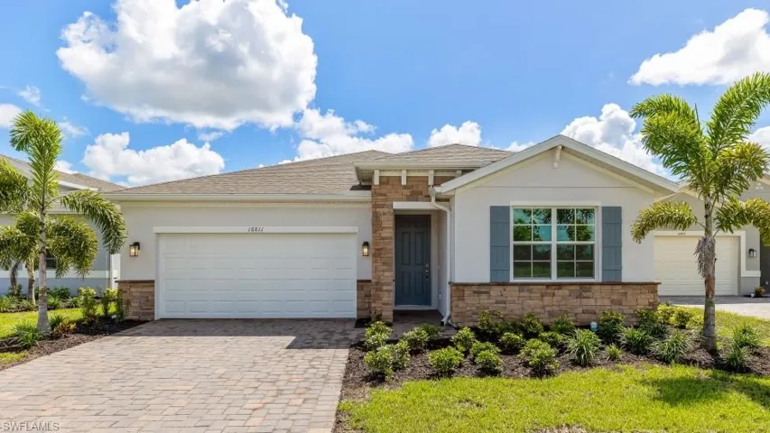 Ranch-style house with stone siding, an attached garage, and stucco siding