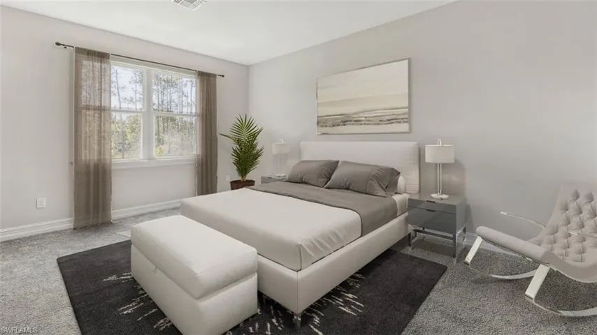 This image is virtually staged. Bedroom with carpet floors and baseboards