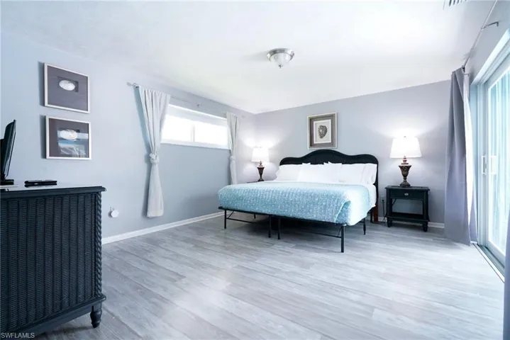 Bedroom with light wood finished floors and baseboards