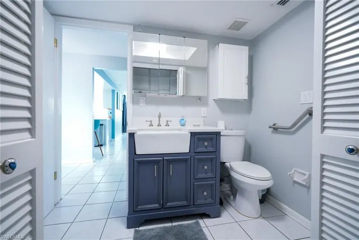 Bathroom with tile patterned floors and vanity