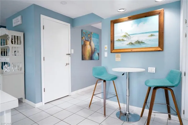 Dining area with light tile patterned floors and baseboards