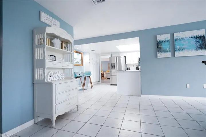 Living area featuring light tile patterned flooring and baseboards