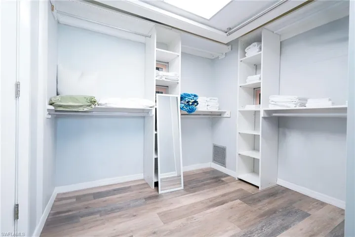 Walk in closet featuring wood finished floors