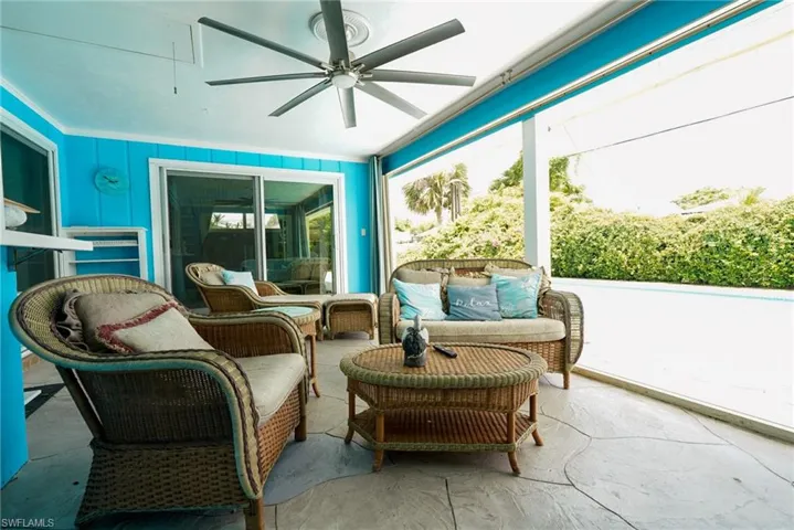 Sunroom / solarium with ceiling fan and an outdoor living space