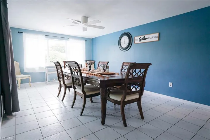 Dining room with light tile patterned flooring and ceiling fan