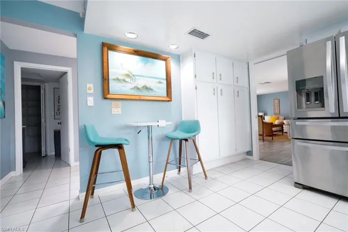 Dining area with light tile patterned floors