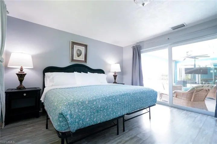 Bedroom featuring access to outside and wood finished floors
