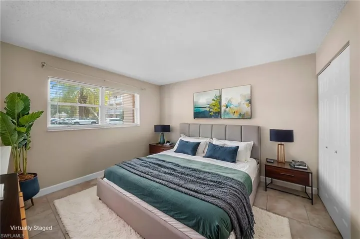 Bedroom with a closet and light tile patterned floors