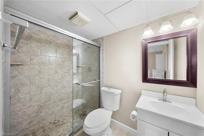 Full bathroom featuring vanity and a shower stall