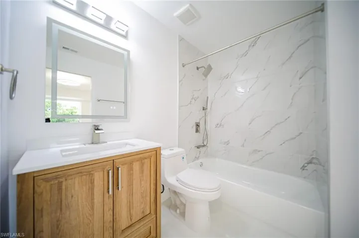 Bathroom featuring vanity and  shower combination
