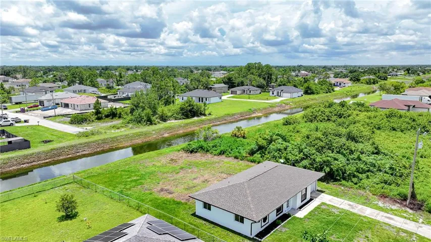 Aerial perspective of suburban area with a nearby body of water