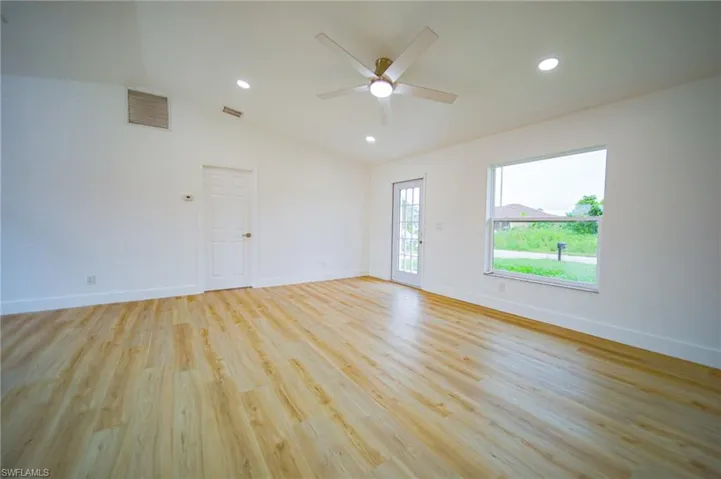 Unfurnished room featuring vaulted ceiling, a ceiling fan, recessed lighting, and light wood-type flooring