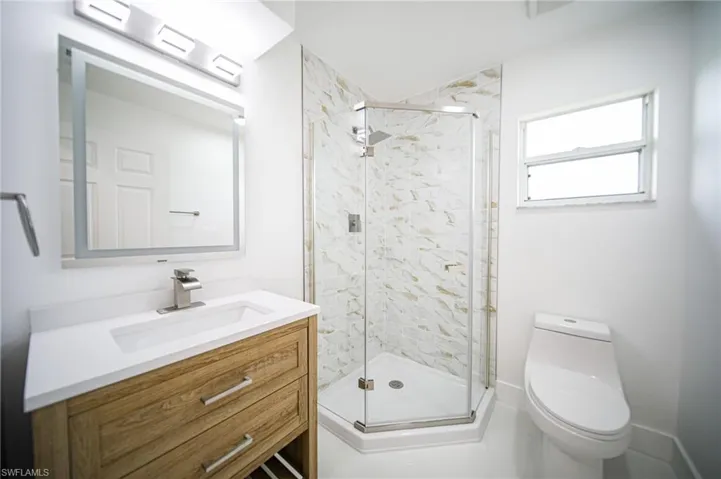 Bathroom featuring vanity and a stall shower