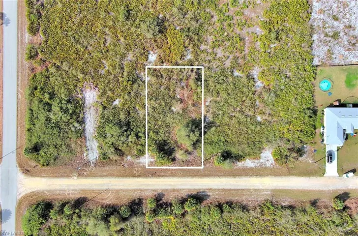 Aerial view of property and surrounding area featuring property boundaries highlighted