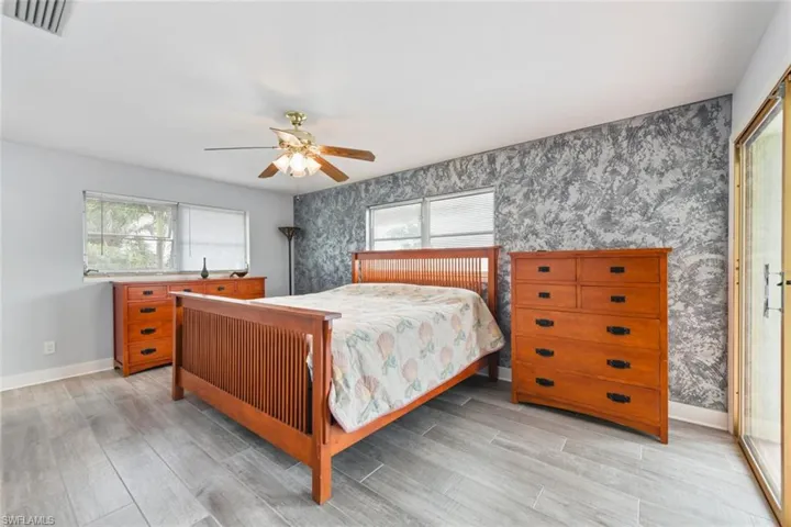 Bedroom featuring light hardwood / wood-style flooring and ceiling fan