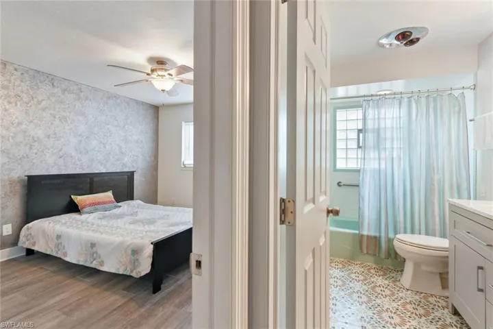 Bedroom with ceiling fan and light hardwood / wood-style flooring