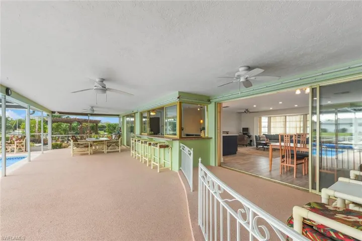 View of patio / terrace featuring ceiling fan and exterior bar