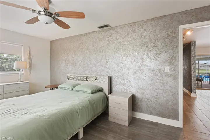 Bedroom featuring ceiling fan and dark wood-type flooring