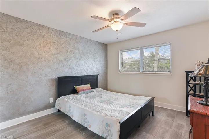 Bedroom with wood-type flooring and ceiling fan