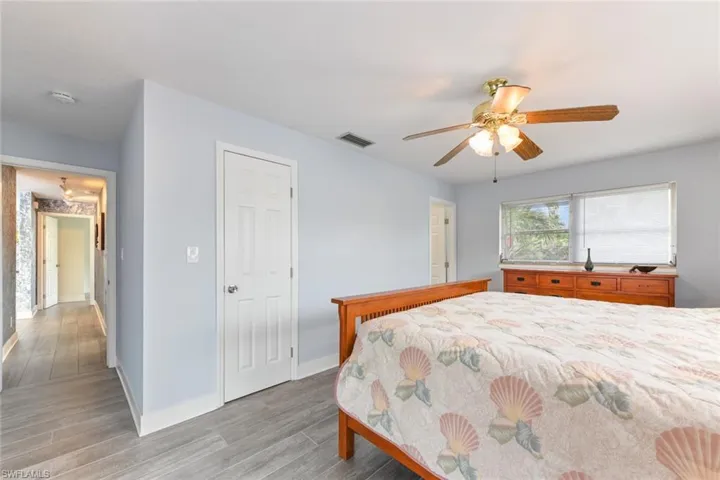 Bedroom with ceiling fan and light hardwood / wood-style floors