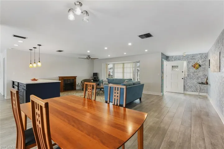 Dining area with ceiling fan and light hardwood / wood-style flooring