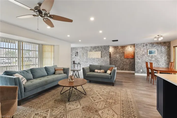 Living room featuring ceiling fan and hardwood / wood-style flooring