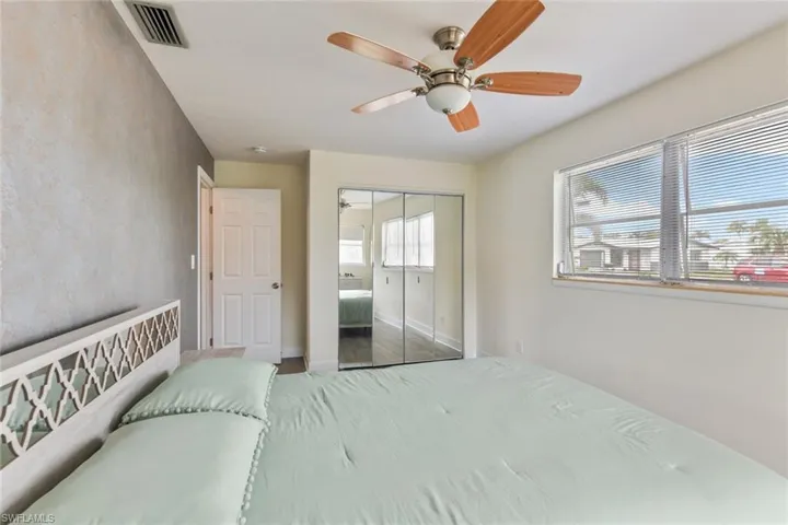 Bedroom with wood-type flooring, a closet, and ceiling fan