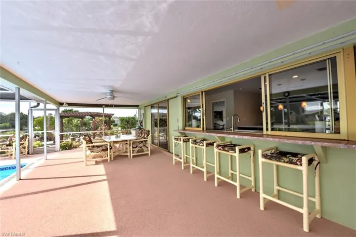 Sunroom / solarium with ceiling fan and sink