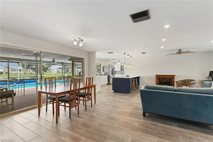 Dining area with light wood-type flooring and ceiling fan