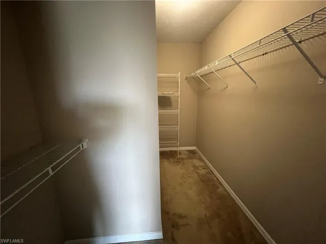 Primary bedroom walk in closet