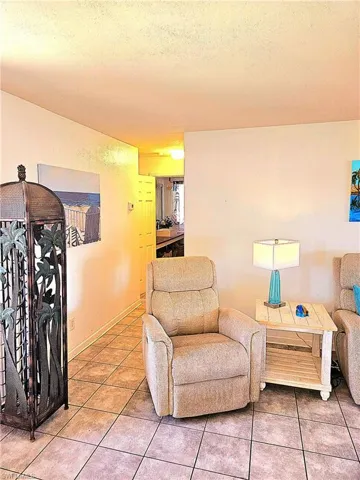 Living area has tile floors and sliding doors to large lanai