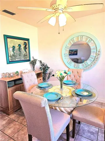 Bright and spacious dining area featuring tile flooring and ceiling fan