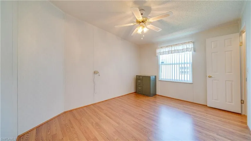 Carpet? No! The guest bedroom features laminate flooring and a walk-in closet.