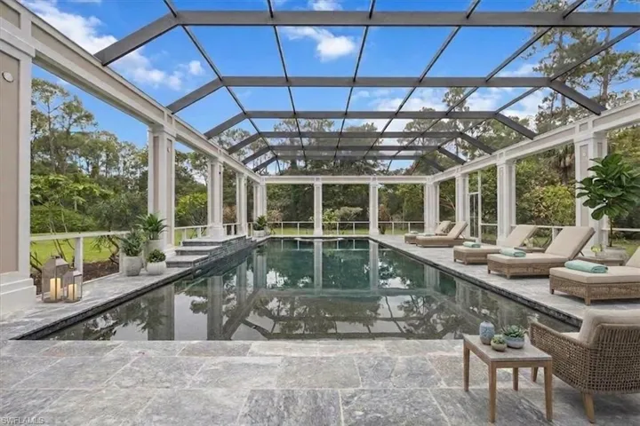Virtually staged. Resort-style covered pool amidst the 5-acre estate