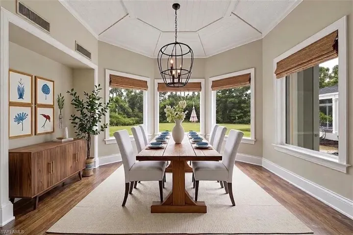 Virtually staged. Sunlit dining room overlooking estate lawn