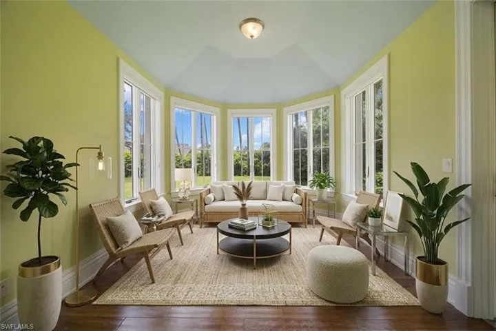 Virtually staged. Sun room overlooking estate lawn and pool