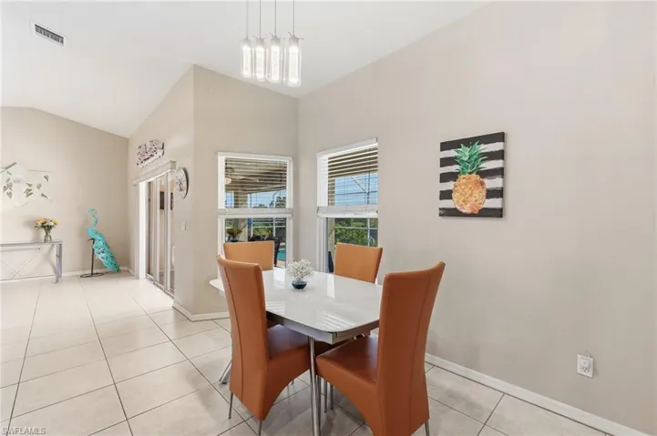 Contemporary fixtures and table with views of pool & canal.