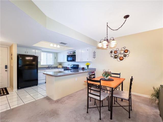 Dinning room table looking to the bright kitchen.