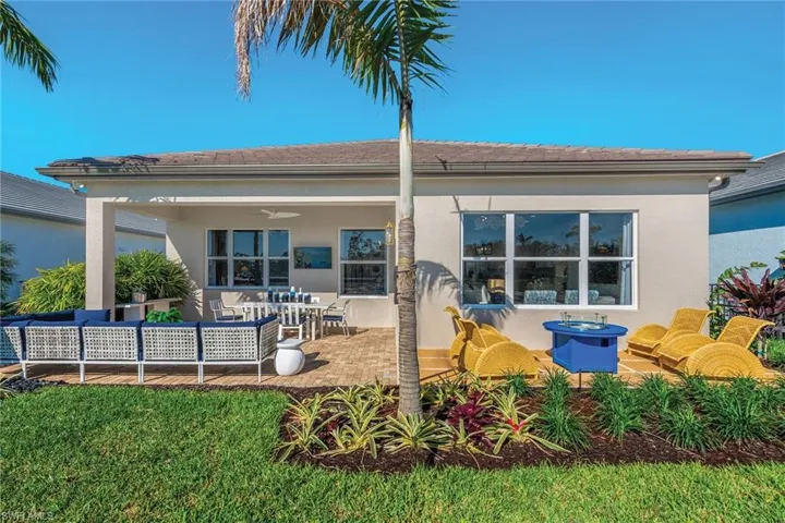 Rear view of house with a patio area, a ceiling fan, a tile roof, and stucco siding