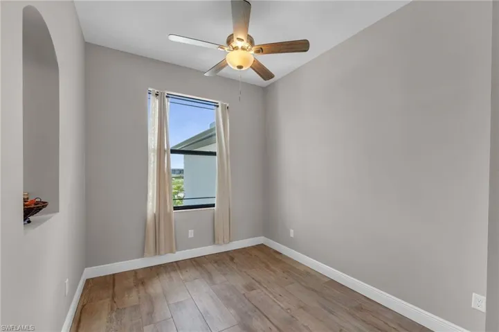 Empty room with light wood-style flooring and ceiling fan