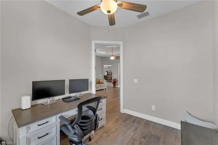 Office space featuring light wood-style floors and a ceiling fan