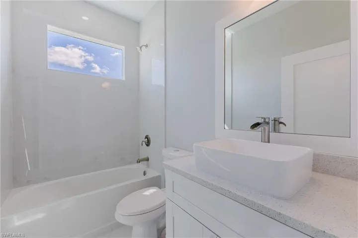 Bathroom with vanity and bathing tub / shower combination