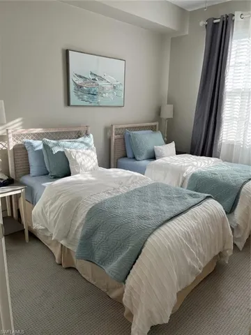 Bedroom with carpet flooring and multiple windows