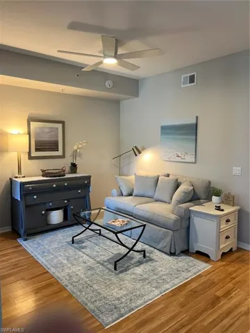 Living room featuring ceiling fan and hardwood / wood-style flooring