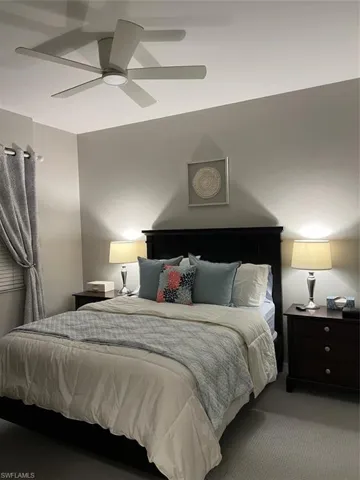 Bedroom with ceiling fan and carpet floors