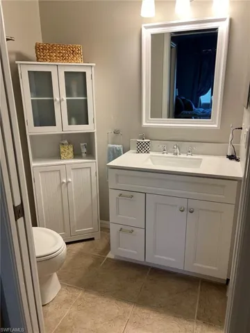 Bathroom featuring tile flooring, toilet, and vanity