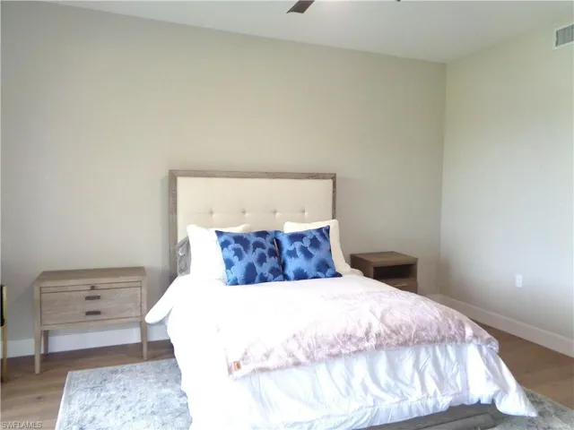 Bedroom with wood finished floors and ceiling fan