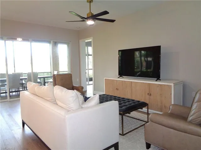 Living room with a ceiling fan and wood finished floors