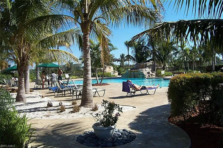 Community pool with a patio