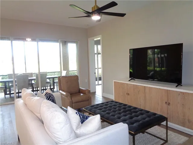 Living area with wood finished floors and ceiling fan
